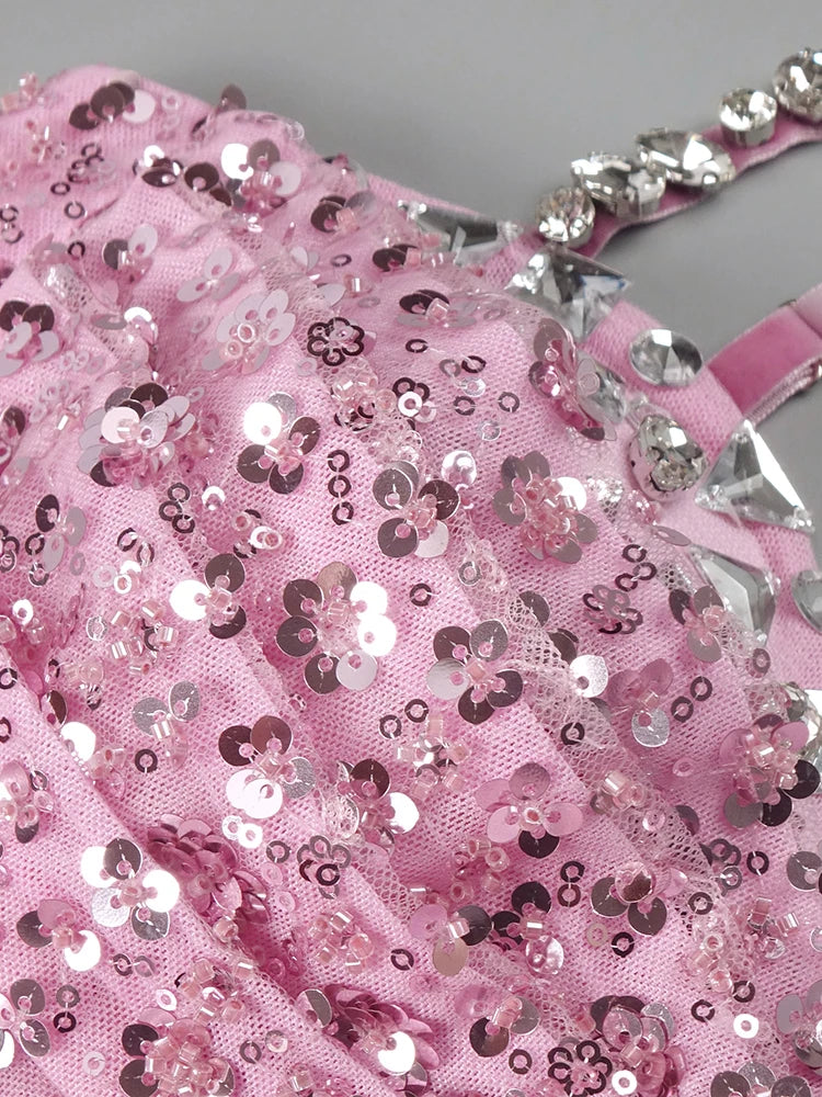 Pink glittery fabric with silver sequins on a gray background