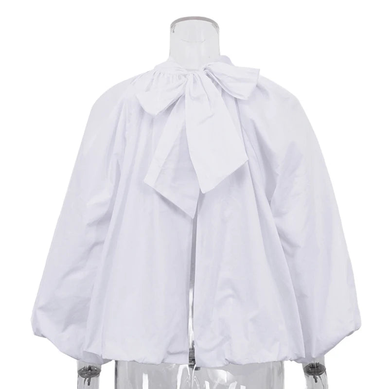 White blouse with a bow on a mannequin against a white background