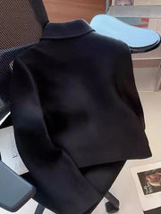 Black jacket on a chair in an office setting