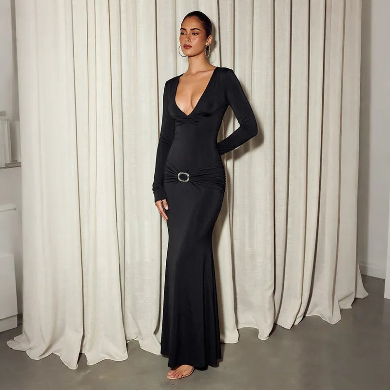 Black plunge neck long sleeve maxi dress styled from the side