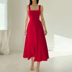 Red dress worn by a person in a minimalistic setting