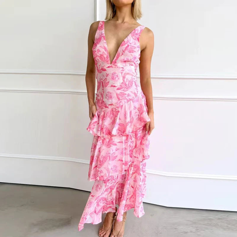 Woman wearing a pink floral dress against a white wall