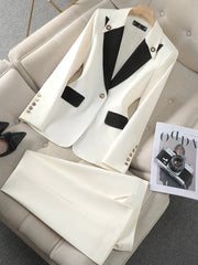 White blazer with black lapels on a beige sofa next to a magazine.