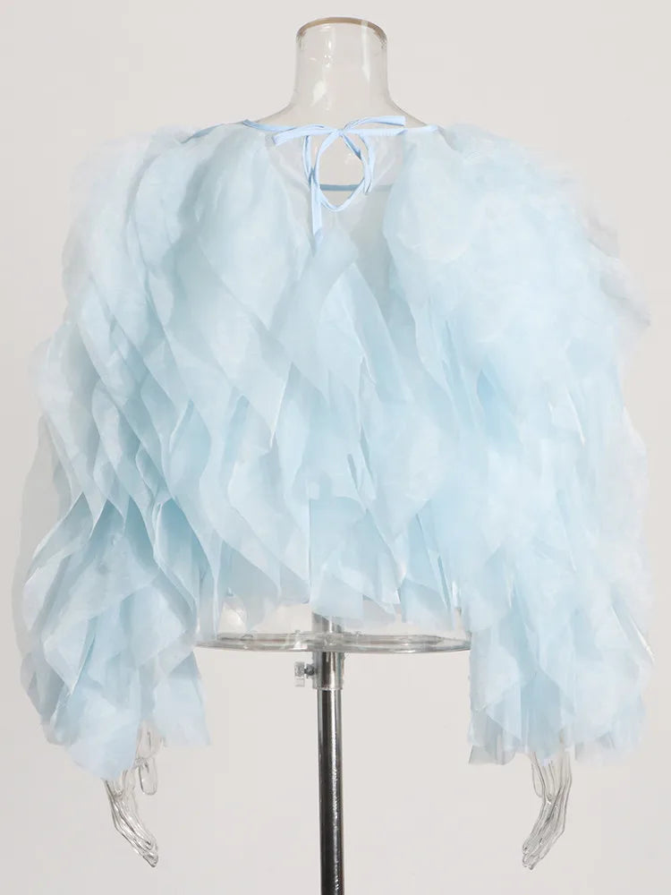 Light blue ruffled top on a mannequin against a white background