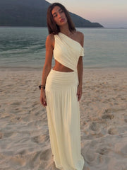 One-shoulder cutout ruched maxi dress on a woman at the beach.