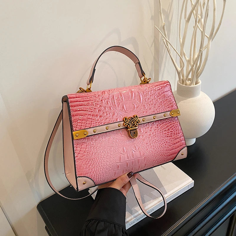 Pink crocodile embossed handbag with gold clasp