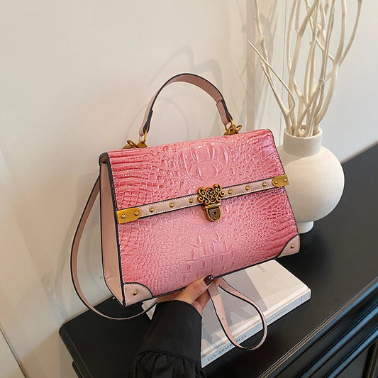 Pink crocodile embossed handbag with gold clasp