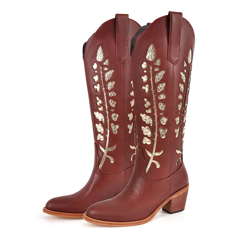 Brown cowboy boots with floral embroidery on a white background