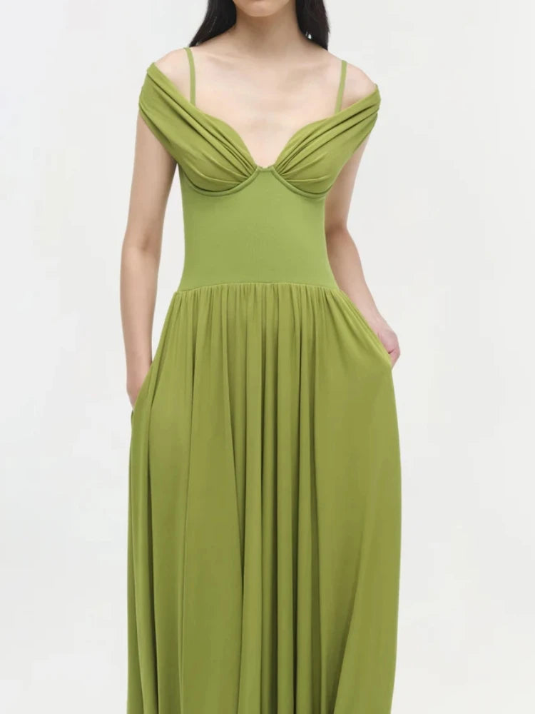 Green dress worn by a model on a white background
