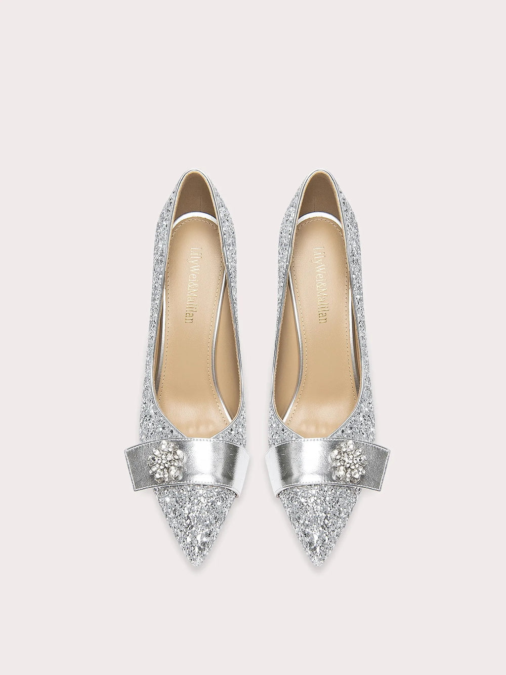 Pair of silver glittery high heels on a white background