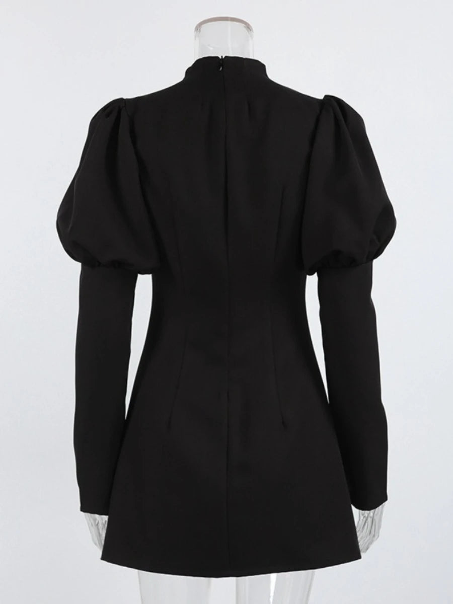 Black dress with puffed sleeves on a mannequin against a white background