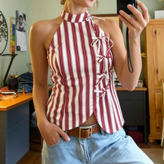Model wearing a red and white striped halter tie-front crop top
