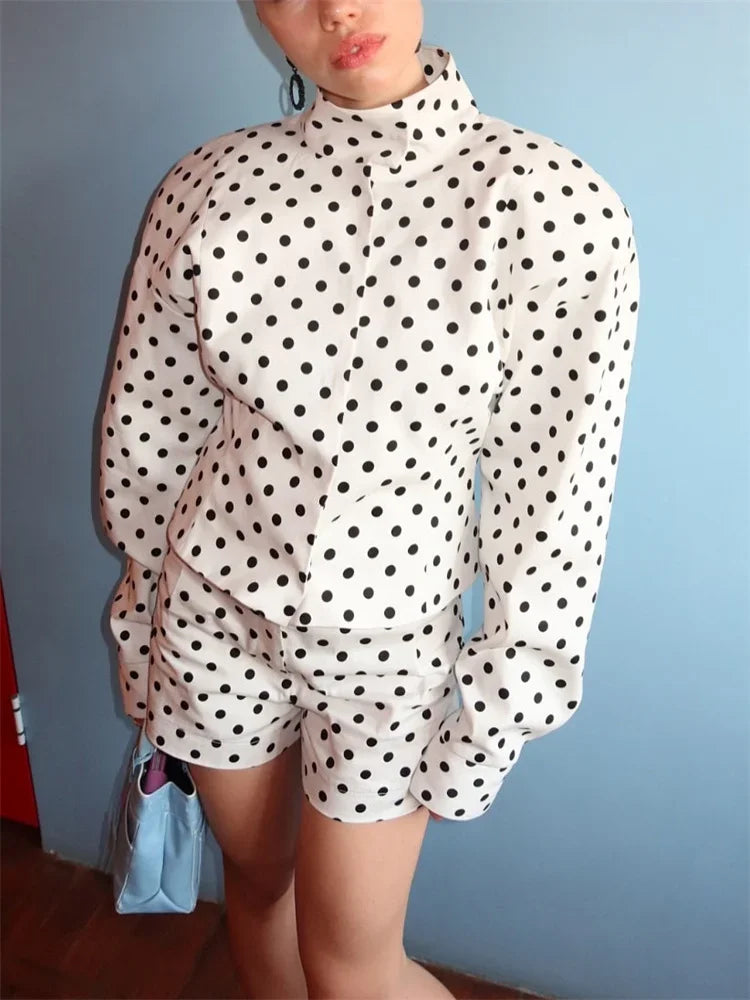 Person wearing a polka dot outfit with a plain background