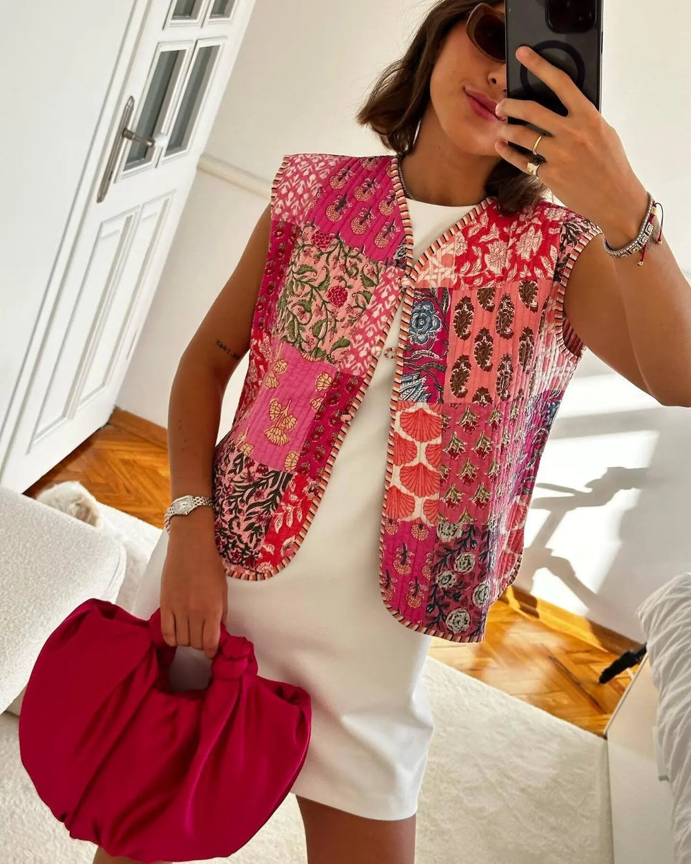 Patchwork floral print quilted vest worn by a model