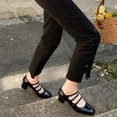  A woman wearing square toe Mary Jane pumps with a buckle strap, showcasing their elegant design. Black. Golden Atelier 3