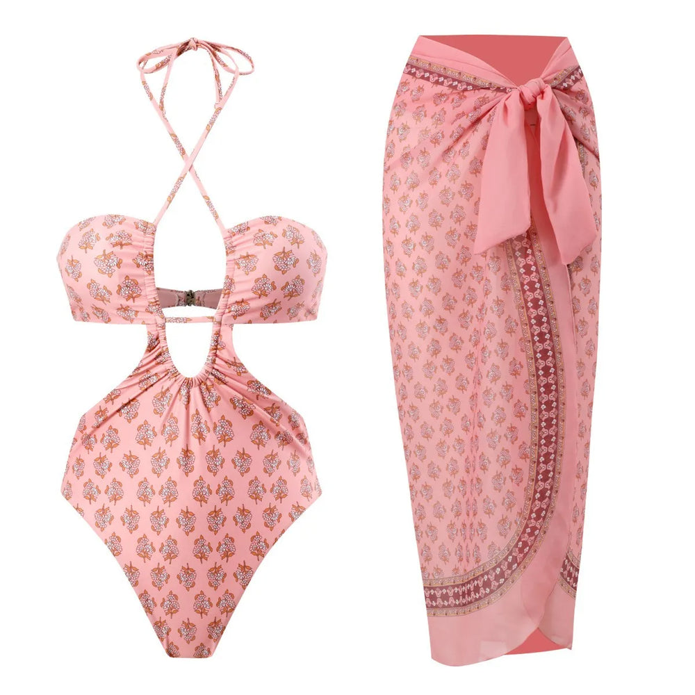 Pink floral printed one-piece swimsuit and matching sarong skirt.