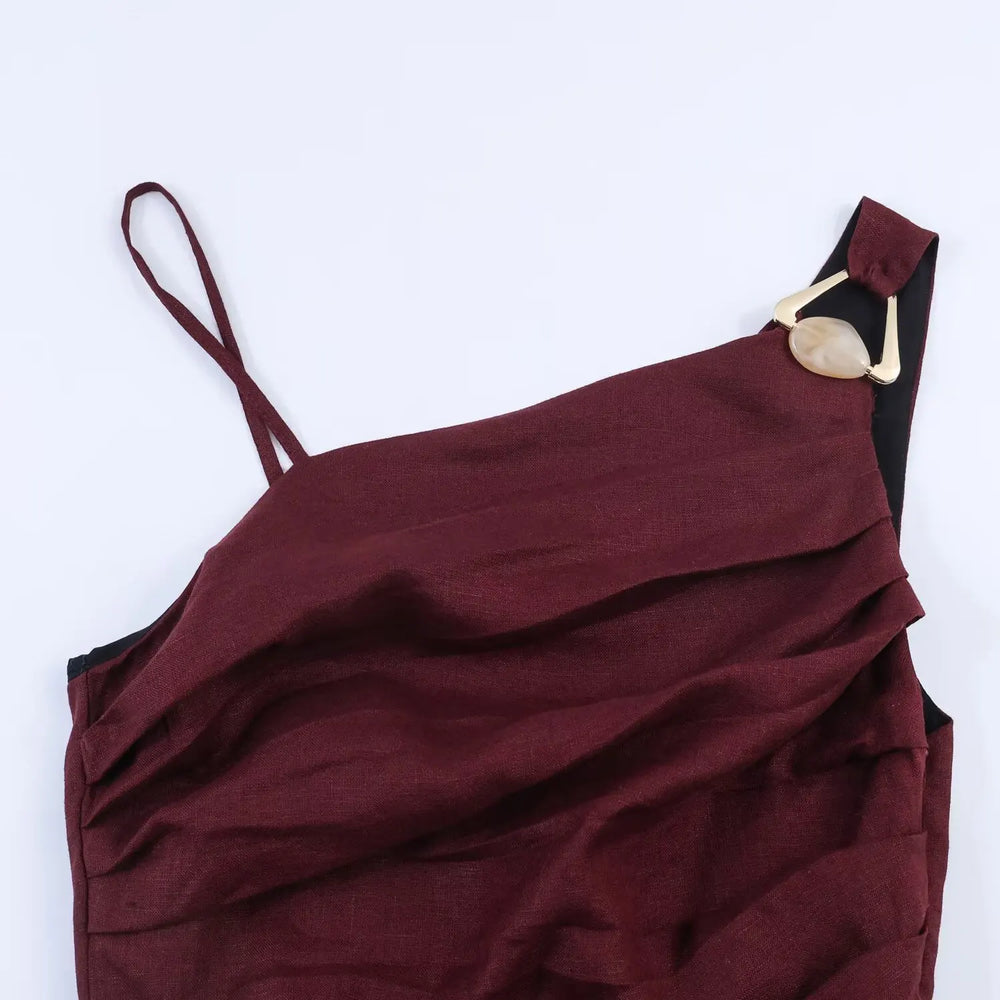 Maroon dress with thin straps and a button detail on a white background