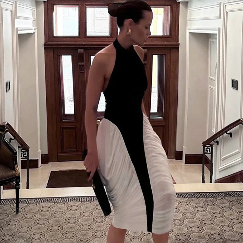 Woman in a black and white dress standing in a formal setting