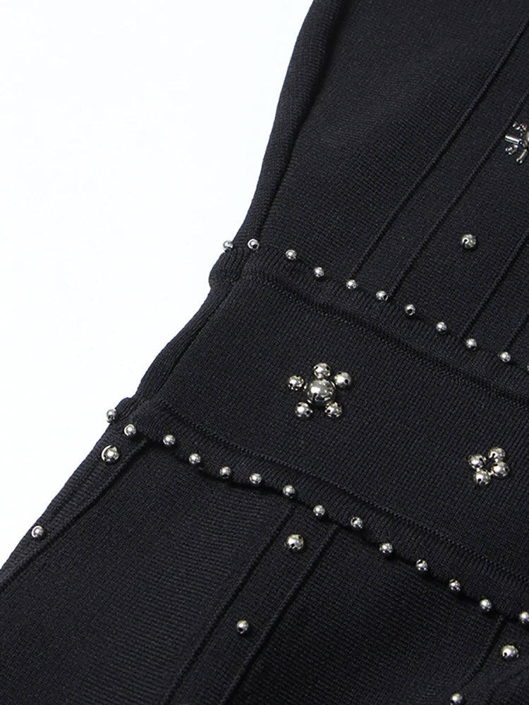 Black garment with silver stud details on a white background