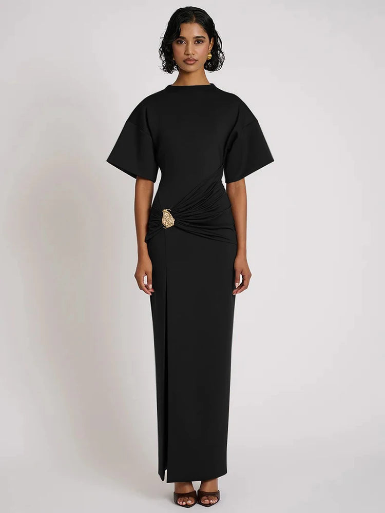 Woman wearing a black dress with a plain background