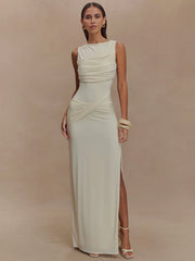 Woman wearing a white sleeveless gown with a slit on a beige background