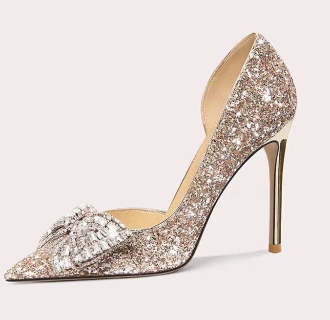 Sparkling high-heeled shoe on a light gray background