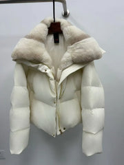 White puffer jacket with fur collar on a hanger against a plain background
