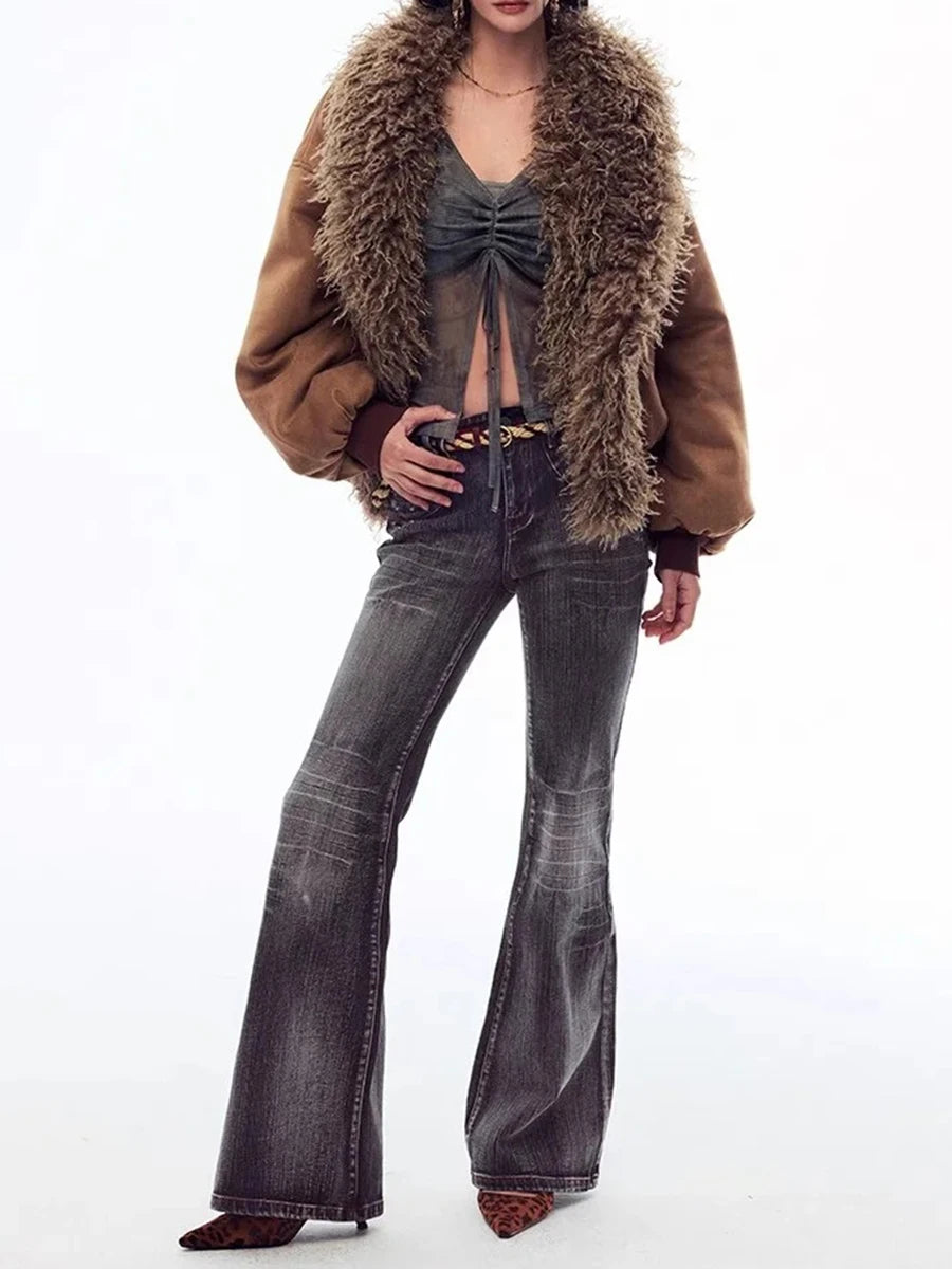 Person wearing a brown fur-trimmed coat and flared jeans