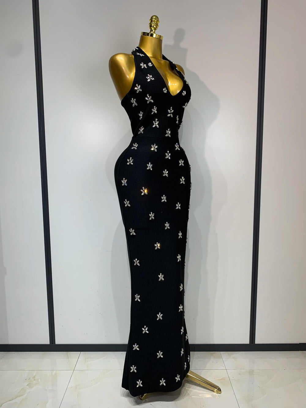 Halter neck sleeveless ankle-length knit bodycon gown with scattered diamond embellishments, side view.