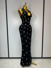 Halter neck sleeveless ankle-length knit bodycon gown with scattered diamond embellishments, side view.