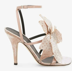 A pair of elegant suede high heel shoes adorned with delicate flower-shaped crystal embellishments.