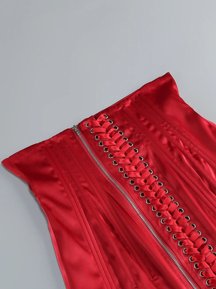 Red dress with lace-up details on a gray background
