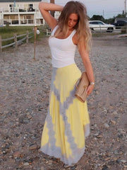 Model wearing yellow lace patchwork maxi skirt on the beach