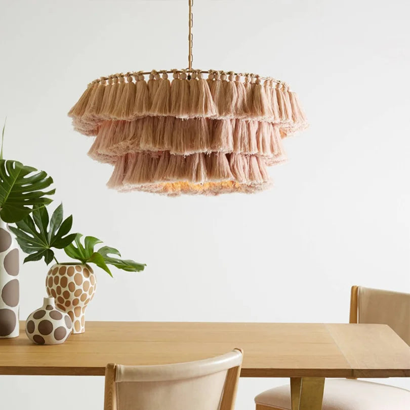 A Fela Tassel Pendant Light with colorful tassels hanging in a boho-chic Dining Room A. Pink A