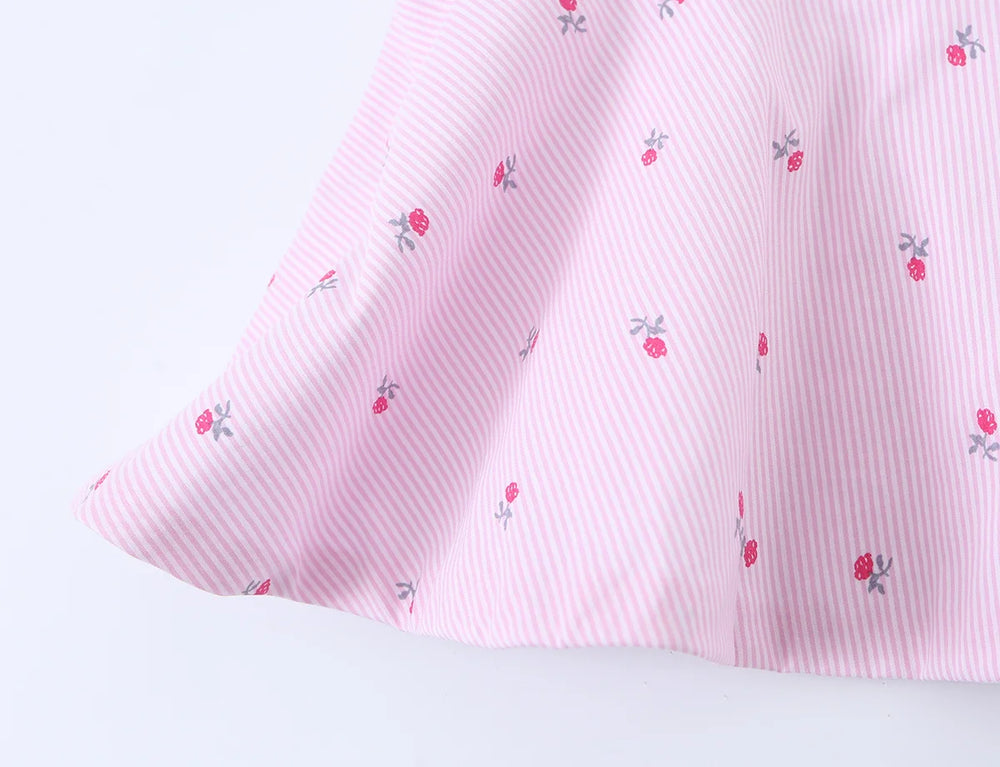 Close-up of the peplum hem on a pink striped floral camisole