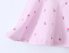 Close-up of the peplum hem on a pink striped floral camisole