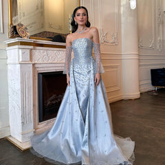 A model wearing the silver-gray evening gown with overskirt, showcasing its flattering silhouette and graceful movement.  Golden Atelier 2