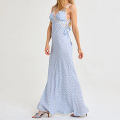 Woman wearing a light blue polka dot dress on a white background