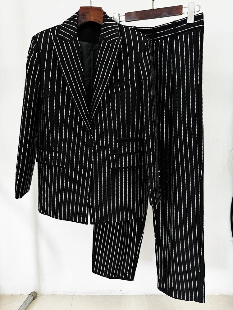 Black and white pinstripe suit on a hanger against a white background