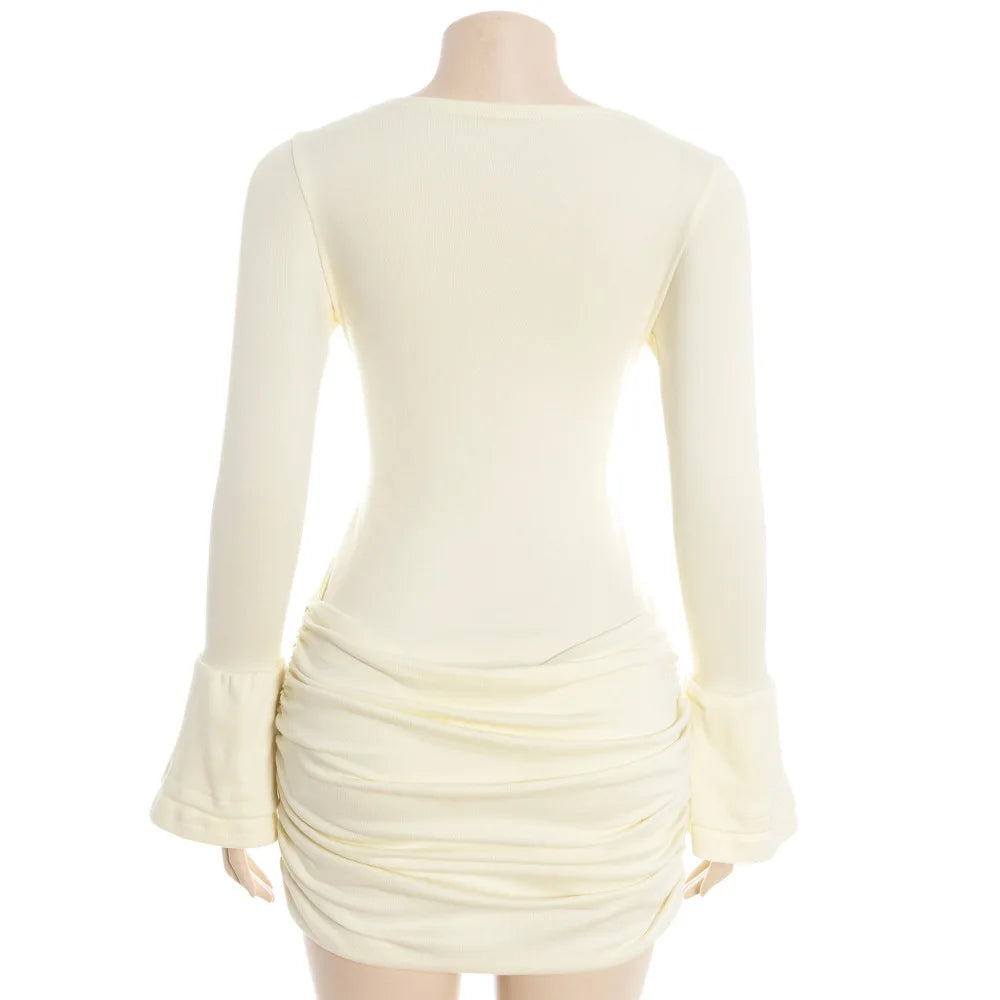 Mannequin wearing a cream-colored dress with long sleeves on a white background
