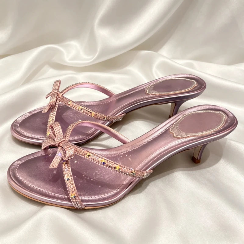 Pair of lavender satin kitten heel dress shoes with crystal bows