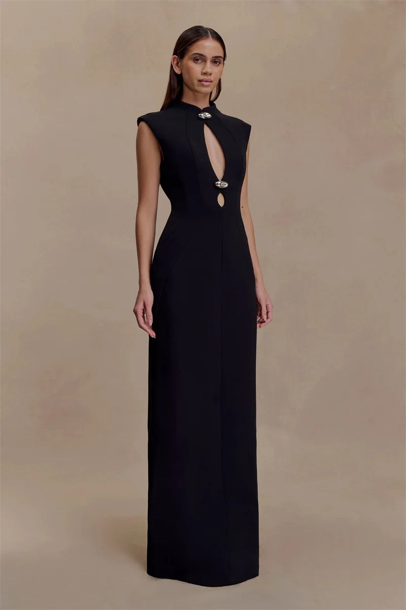 Woman wearing a black evening gown with a deep neckline on a beige background