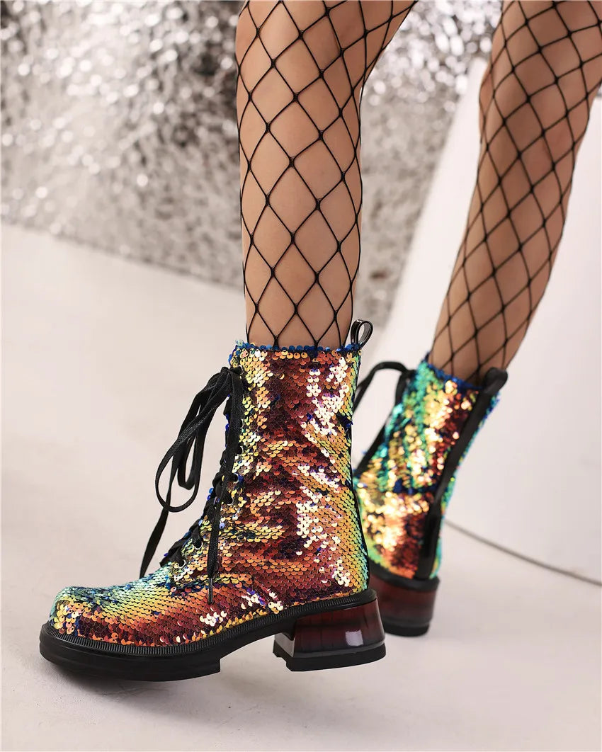 Multicolored sequin boots worn with fishnet stockings on a neutral background