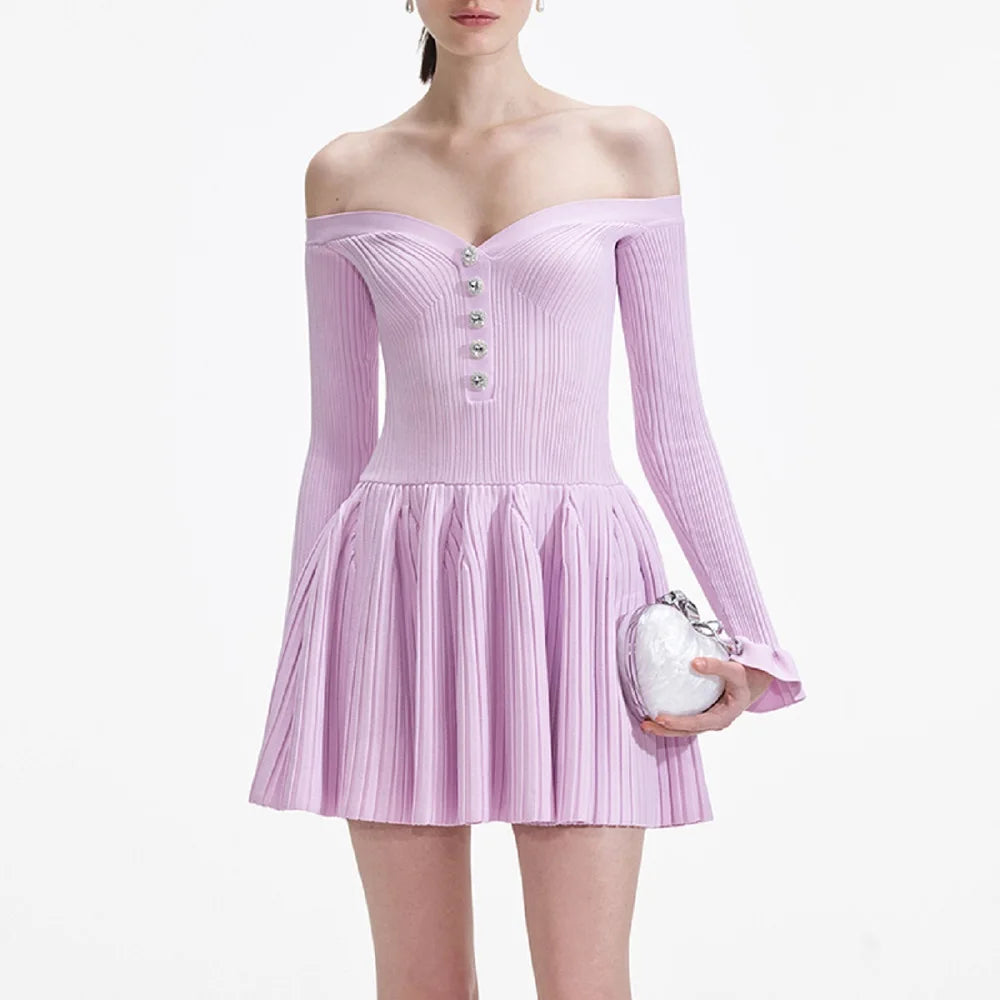 Woman wearing a light purple off-shoulder dress holding a white clutch against a white background