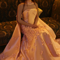  A model wearing the lilac 3D floral gown, showcasing its elegant silhouette and the daring high slit. Golden Atelier 7