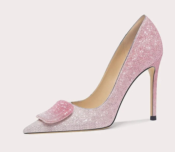 Pink glitter high-heeled shoe with a bow on a white background