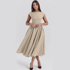 Woman wearing a beige dress on a white background