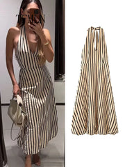 Striped halter neck midi dress worn by a model
