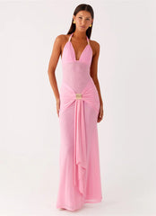 Woman wearing a pink evening gown with a white background