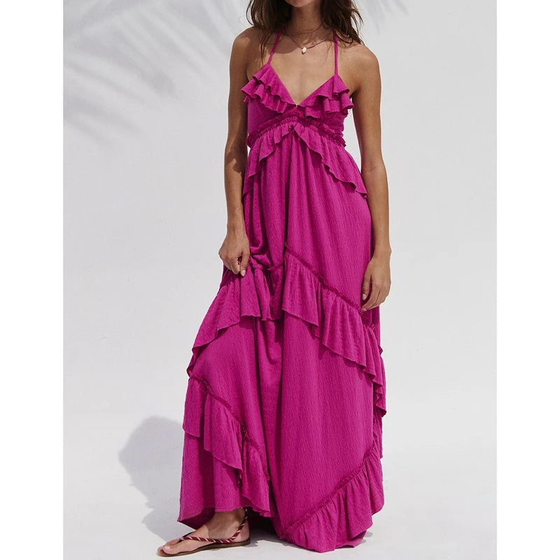 Magenta ruffled halter maxi dress with flowing skirt.